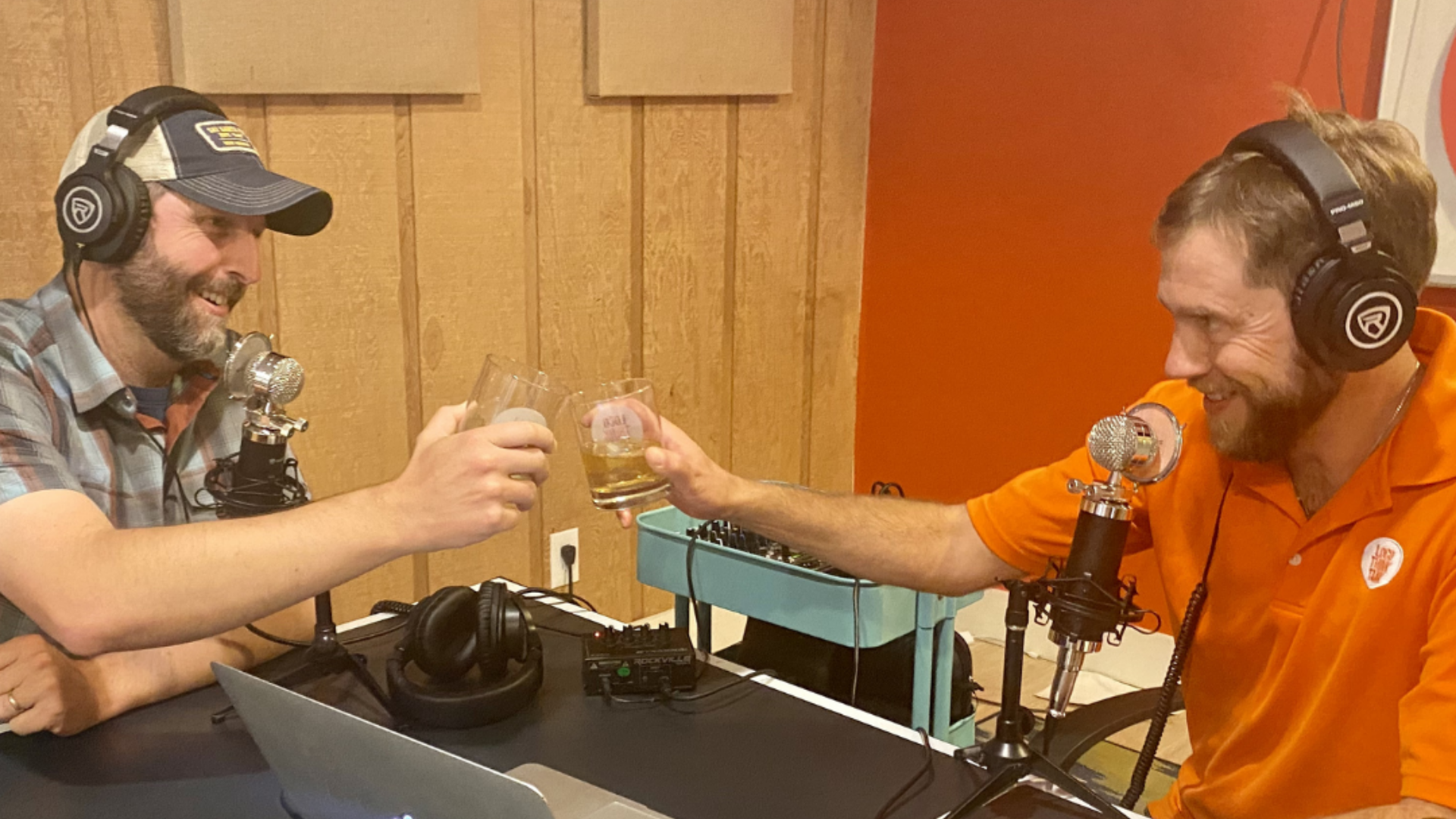 Curt Bear and podcast guest toasting with drinks in the studio